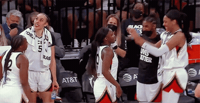 A Group Of Female Basketball Players Are Standing On The Court And One Of Them Is Wearing A Black Shirt That Says Lives  GIF
