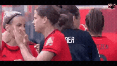 A Group Of Female Soccer Players Are Touching Each Other 'S Faces And One Of Them Has The Name Rer On Her Jersey GIF