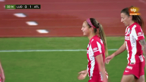 A Group Of Female Soccer Players Wearing Red And White Jerseys With Baxi On Them GIF