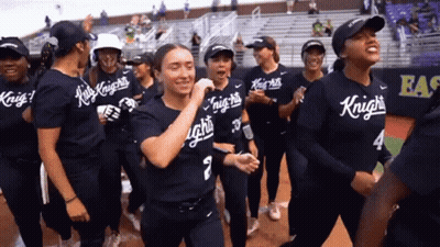 A Group Of Female Softball Players Wearing Shirts That Say Knights On Them GIF