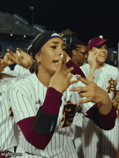 A Group Of Female Softball Players Wearing Striped Uniforms With The Letters Fsu On The Front GIF