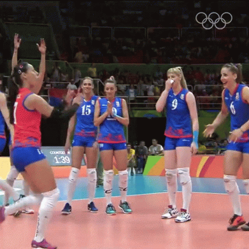 A Group Of Female Volleyball Players Wearing Blue Uniforms With The Number 15 On Them GIF