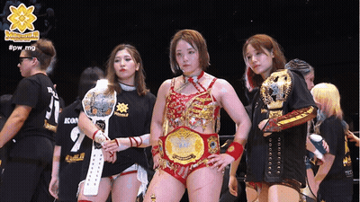 A Group Of Female Wrestlers Standing Next To Each Other With The Hashtag #Pw_mg On The Bottom GIF