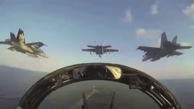 A Group Of Fighter Jets Are Flying In Formation In The Sky GIF