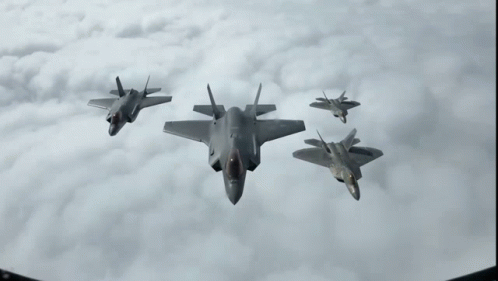 A Group Of Fighter Jets Flying In The Sky GIF