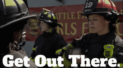 A Group Of Firefighters Standing In Front Of A Banner That Says Get Out There GIF