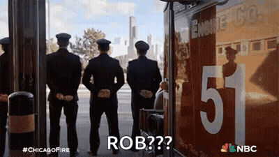 A Group Of Firefighters Standing In Front Of A Fire Truck With The Number 5 On It . GIF