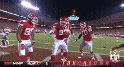 A Group Of Football Players Are Dancing On A Field With The NFL Logo In The Corner GIF