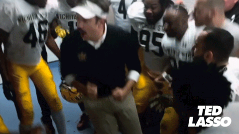 A Group Of Football Players Are Gathered Around A Man Wearing Number 95 GIF