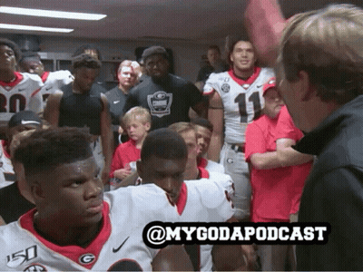 A Group Of Football Players Are Gathered In A Locker Room With The Hashtag @Mygodapodcast GIF