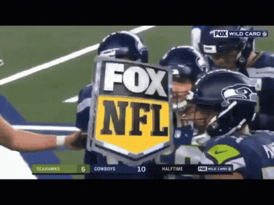 A Group Of Football Players Are Holding A Fox Nfl Shield GIF