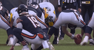 A Group Of Football Players Are Huddled Together And One Of Them Has The Number 22 On Their Jersey GIF