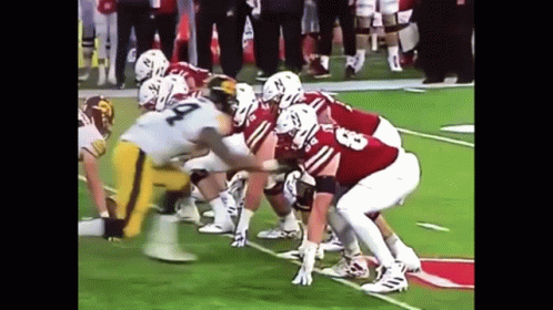 A Group Of Football Players Are Lined Up On The Field And One Of Them Has The Number 23 On Their Jersey GIF