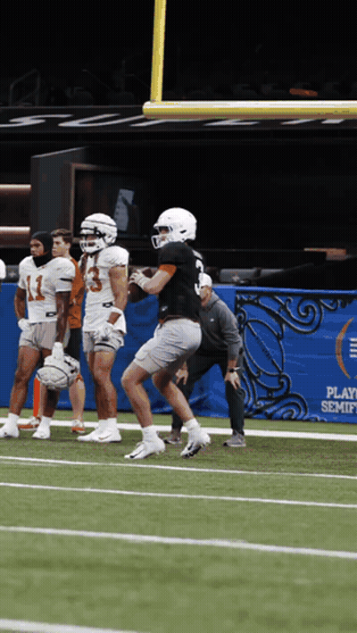 A Group Of Football Players Are On A Field In Front Of A Banner That Says Play Semifinals GIF
