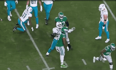 A Group Of Football Players Are On A Field With One Wearing A Number 66 Jersey GIF