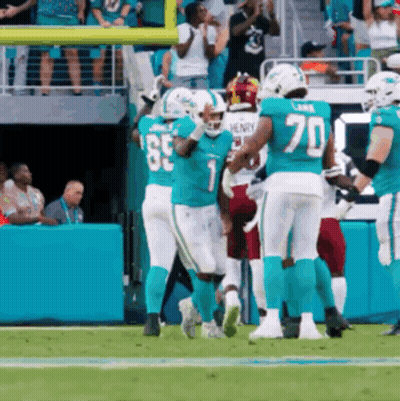 A Group Of Football Players Are On A Field With One Wearing A Number 70 Jersey GIF