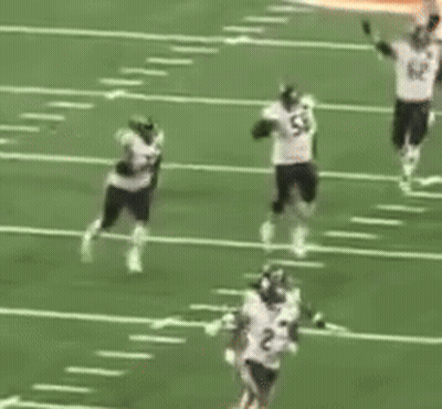 A Group Of Football Players Are On A Field With One Wearing Number 82 GIF
