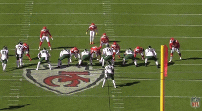 A Group Of Football Players Are On A Field With The Number 14 In The Foreground GIF