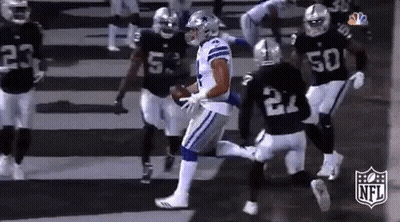 A Group Of Football Players Are Playing A Game Of Football . GIF