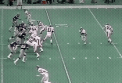 A Group Of Football Players Are Playing A Game On A Field And One Of Them Has The Number 60 On His Jersey GIF