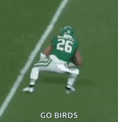 A Group Of Football Players Are Playing A Game On A Field And One Of Them Is Wearing A Number 23 Jersey . GIF