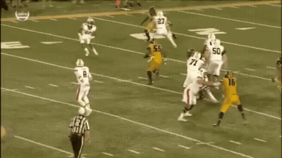 A Group Of Football Players Are Playing A Game On A Field . One Of The Players Has The Number 78 On His Jersey . GIF