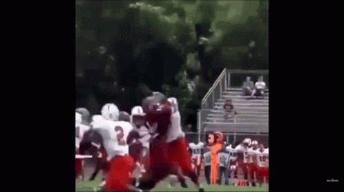 A Group Of Football Players Are Playing On A Field And One Of Them Has The Number 3 On Their Jersey GIF