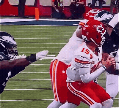 A Group Of Football Players Are Playing On A Field . GIF