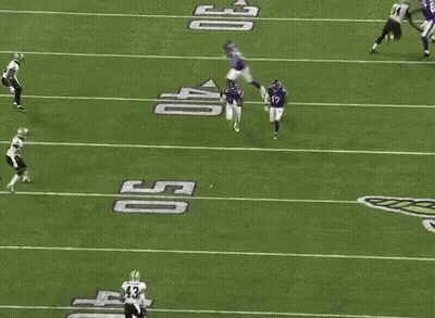 A Group Of Football Players Are Playing On A Field . One Of The Players Has The Number 14 On His Jersey . GIF