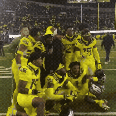 A Group Of Football Players Are Posing For A Photo With One Wearing Number 15 GIF
