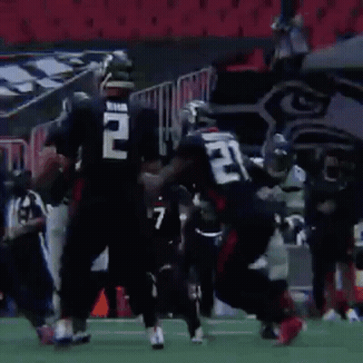 A Group Of Football Players Are Running On A Field With A Sign That Says 40 In The Background . GIF