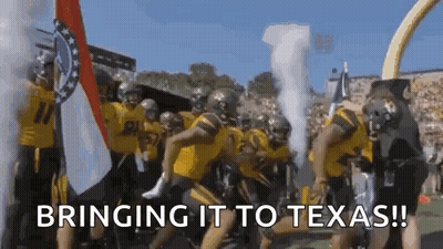 a group of football players are running on a field with the words `` bringing it to texas '' written on the bottom .