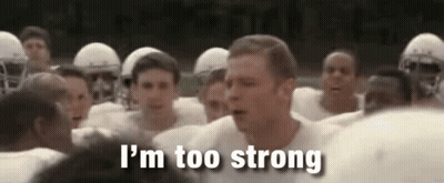 A Group Of Football Players Are Standing In A Huddle And A Man Is Standing In The Middle Of The Group . GIF