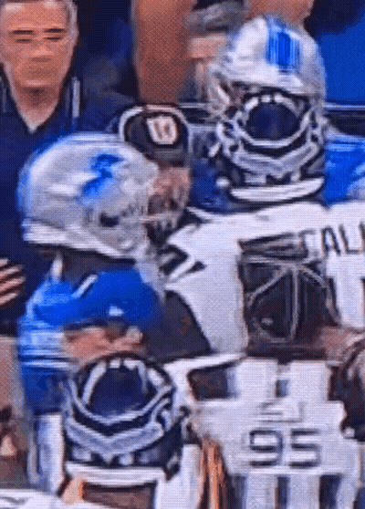 A Group Of Football Players Are Standing Next To Each Other On The Field . GIF