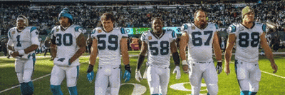 A Group Of Football Players Are Standing On A Field And One Has The Number 67 On His Jersey GIF