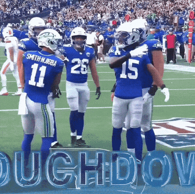 A Group Of Football Players Are Standing On A Field And One Of Them Has The Number 15 On His Jersey GIF