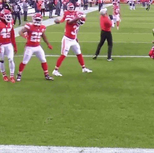 A Group Of Football Players Are Standing On A Field And One Of Them Has The Number 22 On His Jersey GIF