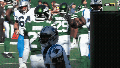 A Group Of Football Players Are Standing On A Field And One Of Them Has The Number 29 On His Jersey GIF