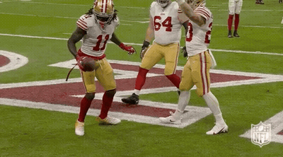 A Group Of Football Players Are Standing On A Field . One Of The Players Has The Number 11 On His Jersey . GIF