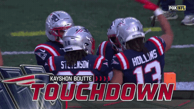 A Group Of Football Players Celebrate A Touchdown GIF