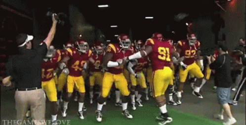 A Group Of Football Players In Red Uniforms With The Number 91 On The Back GIF
