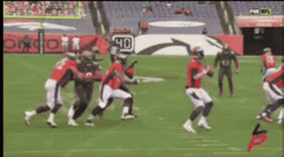 A Group Of Football Players On A Field With A Sign That Says 40 On It GIF