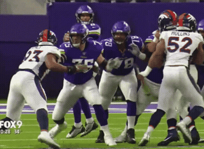 A Group Of Football Players On A Field With One Wearing The Number 52 GIF