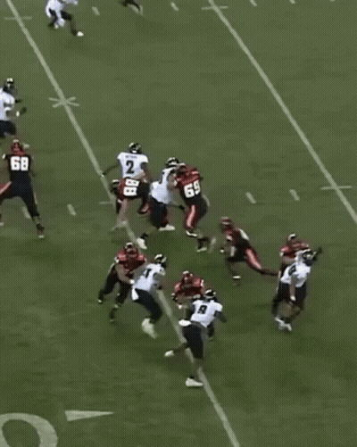 A Group Of Football Players On A Field With One Wearing The Number 68 GIF
