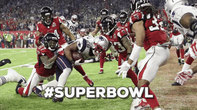 A Group Of Football Players On A Field With #Superbowl Written In The Upper Right Corner GIF