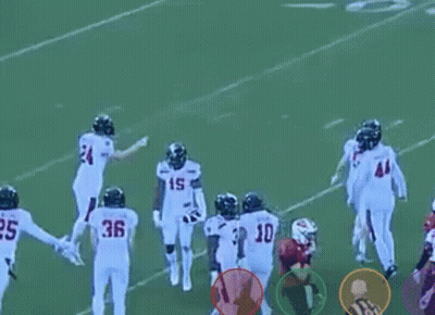 A Group Of Football Players Standing On A Field . GIF