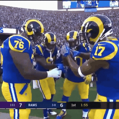 A Group Of Football Players Wearing Blue And Yellow Uniforms With The Number 76 And 17 On Them GIF