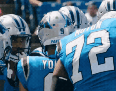 A Group Of Football Players Wearing Blue Uniforms With The Number 72 On Them GIF