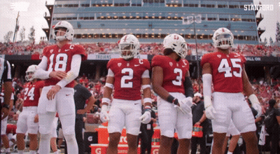 A Group Of Football Players Wearing Red And White Uniforms With The Number 2 On The Back GIF