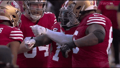 A Group Of Football Players Wearing Red Jerseys With The Number 5 On The Front GIF